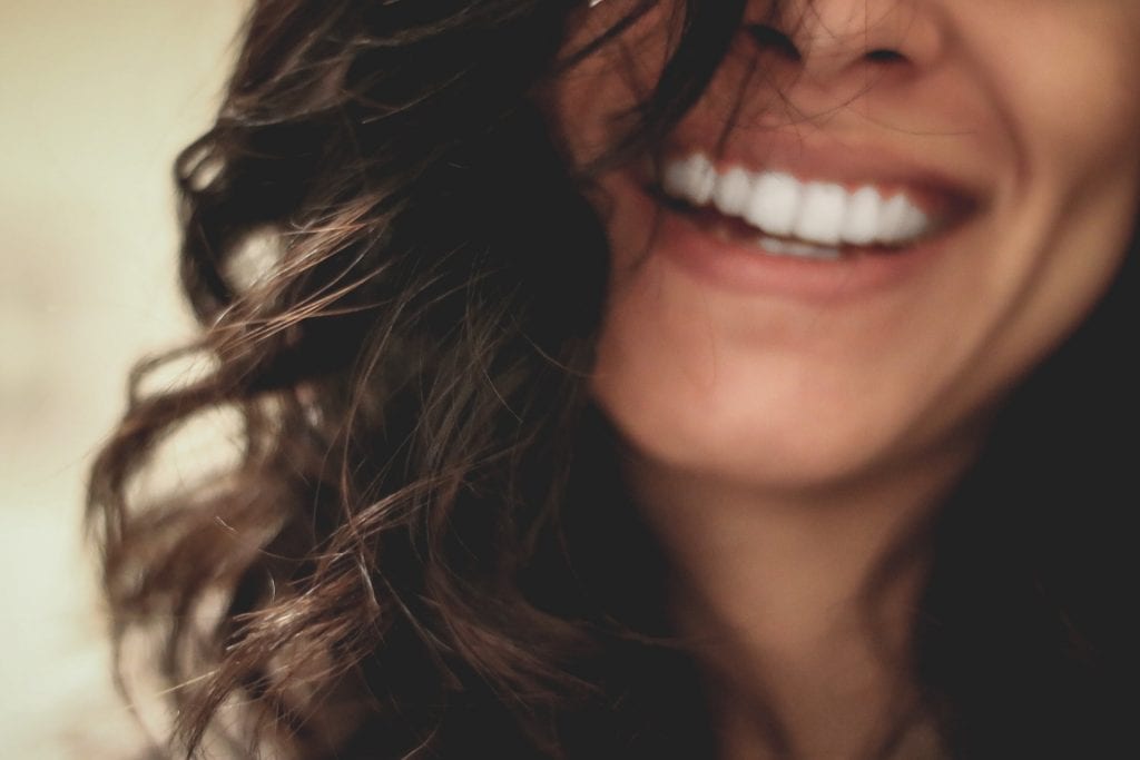 Close up of a woman's mouth smiling.