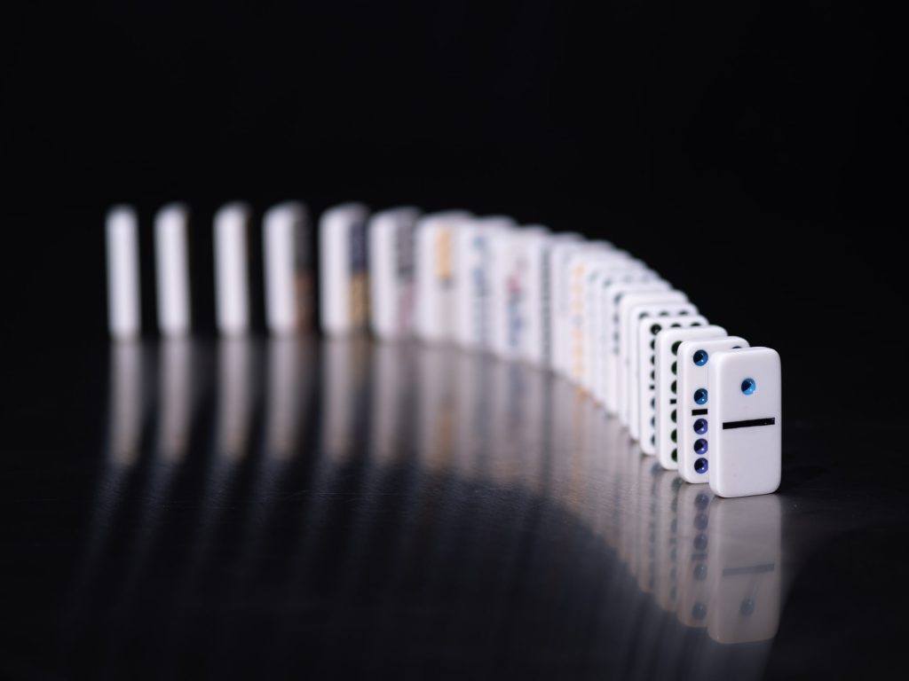 dominoes lined up on a black surface