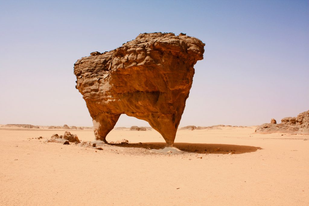 large rock being held up by two thin columns