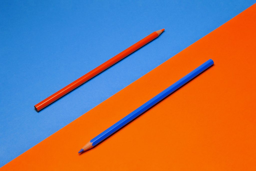 red pencil on blue background, blue pencil on red background