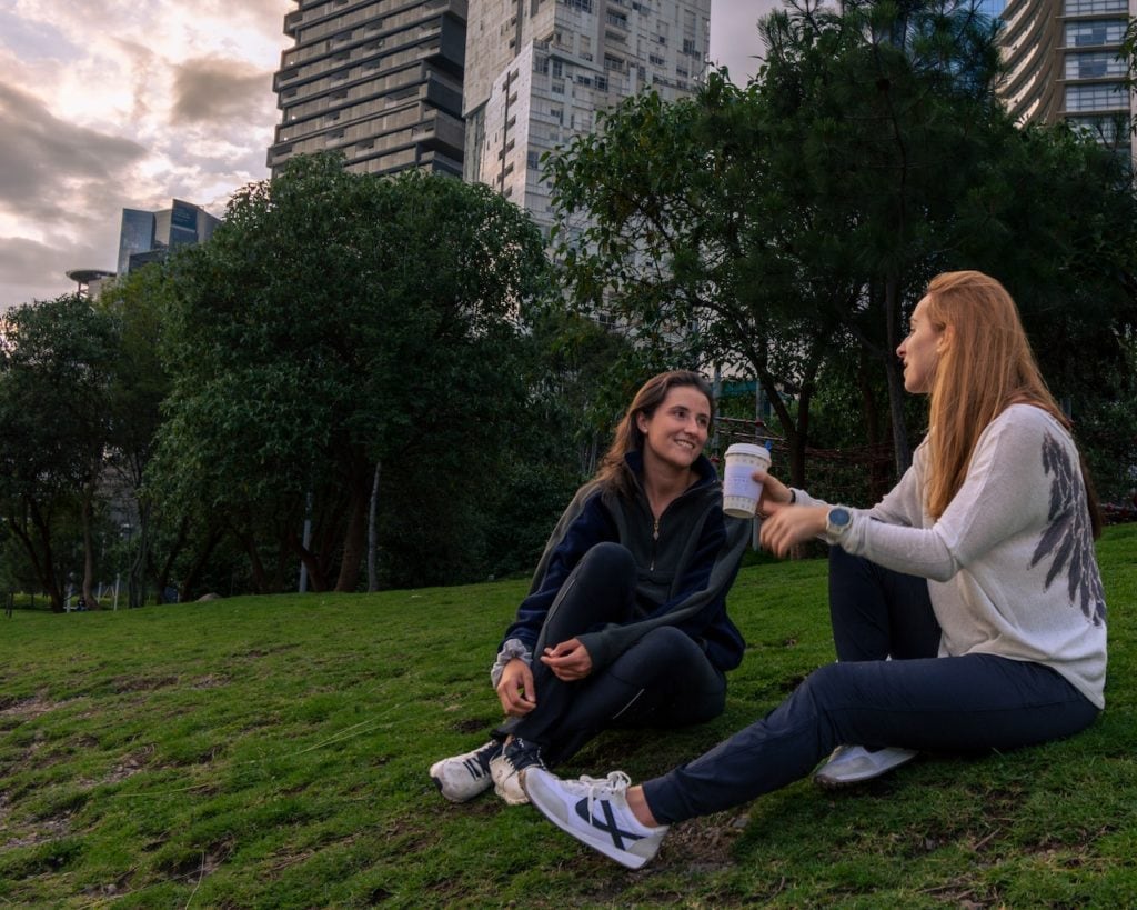 two women having coffee in a park