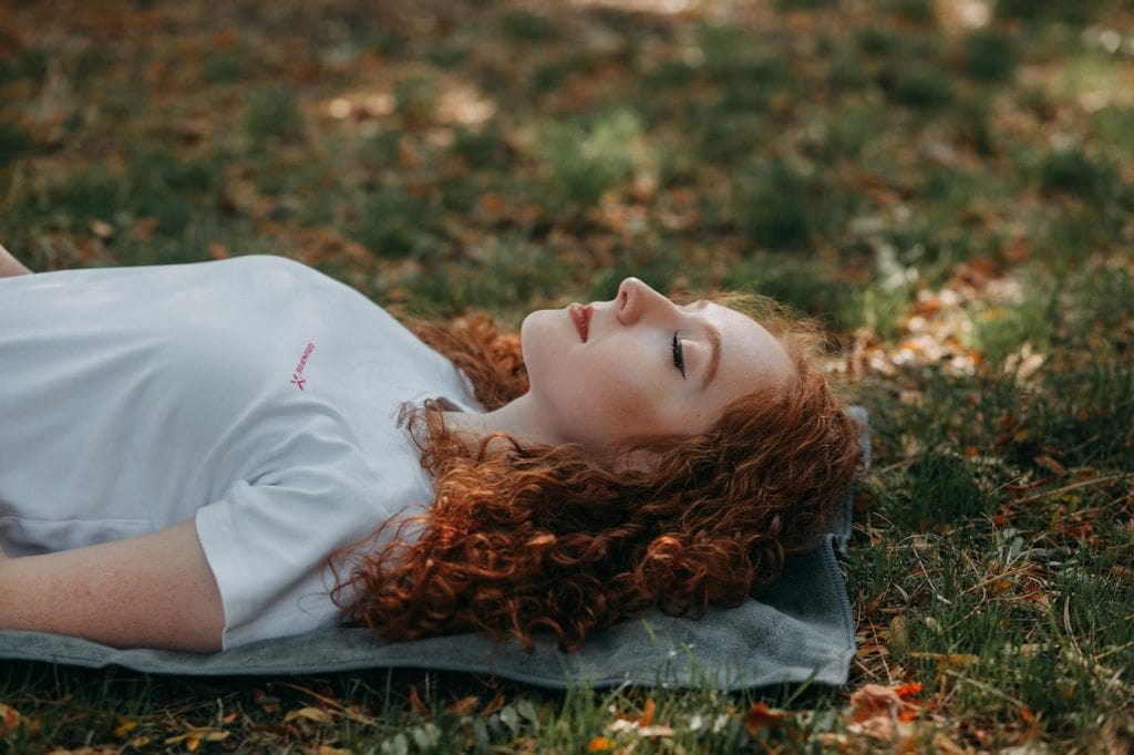 woman lying down in nature
